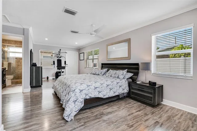 a bedroom with a bed and wooden floor