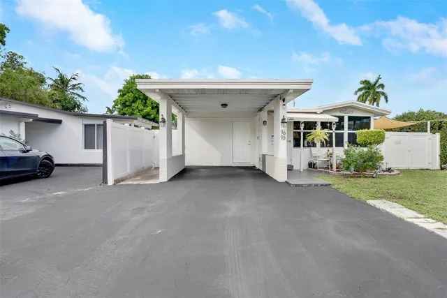 a view of a house with a yard and garage
