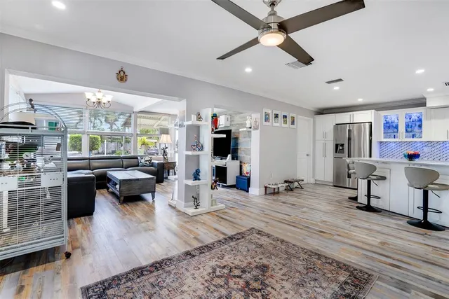 a living room with furniture a rug and a chandelier