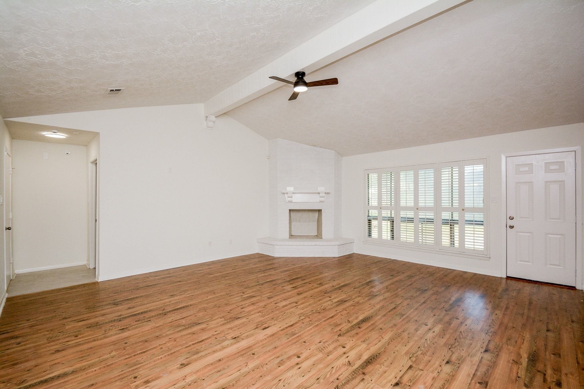 4307 Sloangate Drive Spring, TX 77373 - Photo 11 of 22 a view of an empty room with wooden floor and a window