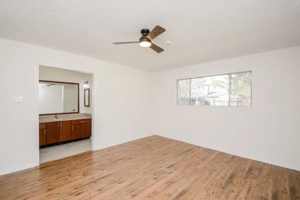a room with a window and wooden floor