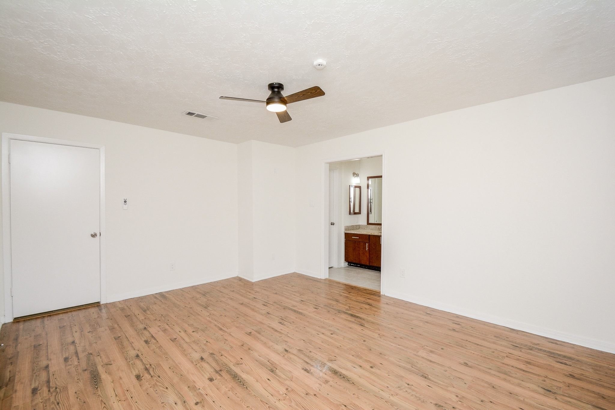 4307 Sloangate Drive Spring, TX 77373 - Photo 13 of 22 a view of empty room with wooden floor and ceiling fan