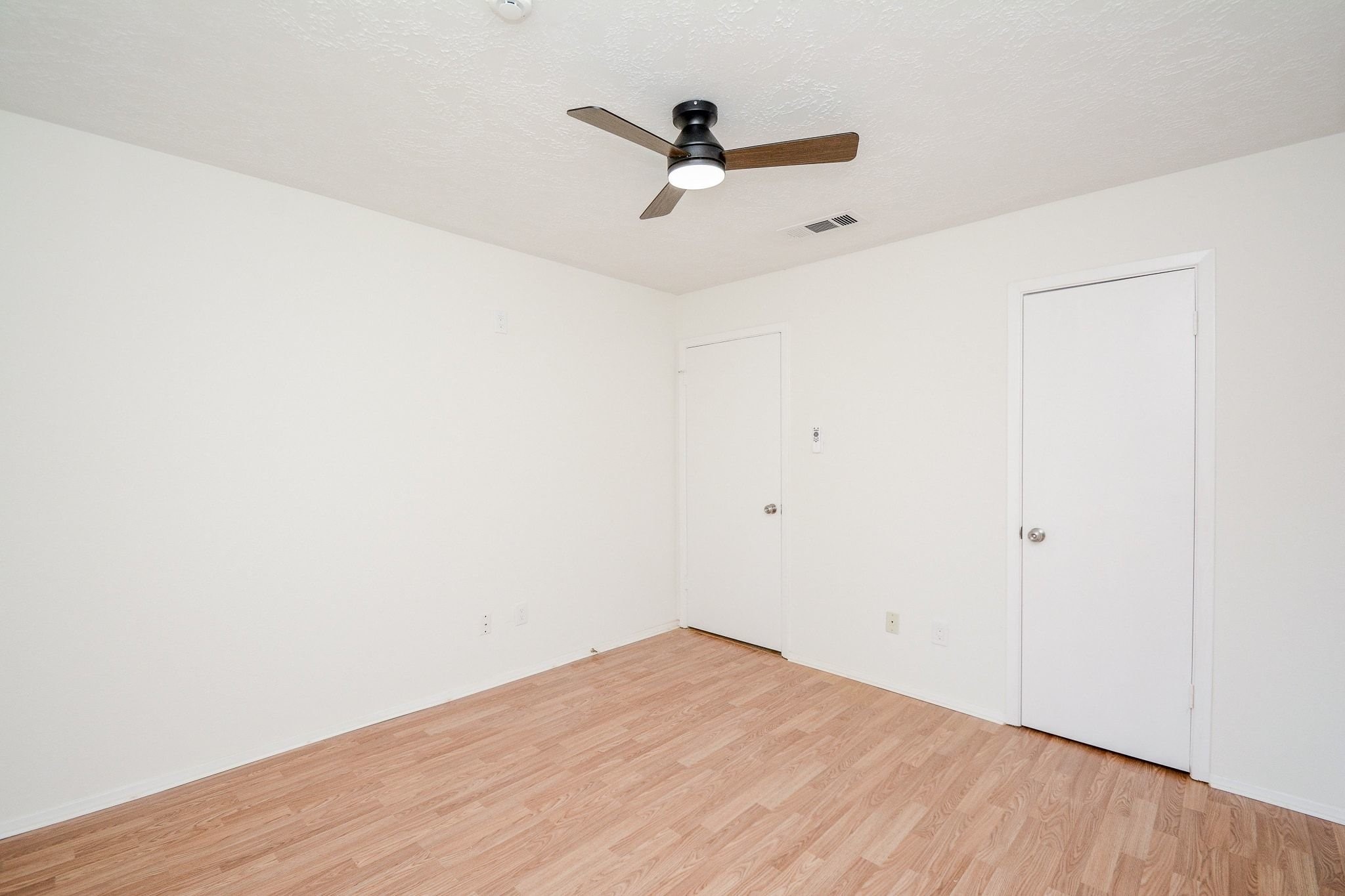 4307 Sloangate Drive Spring, TX 77373 - Photo 15 of 22 a view of a room with wooden floor and a ceiling fan