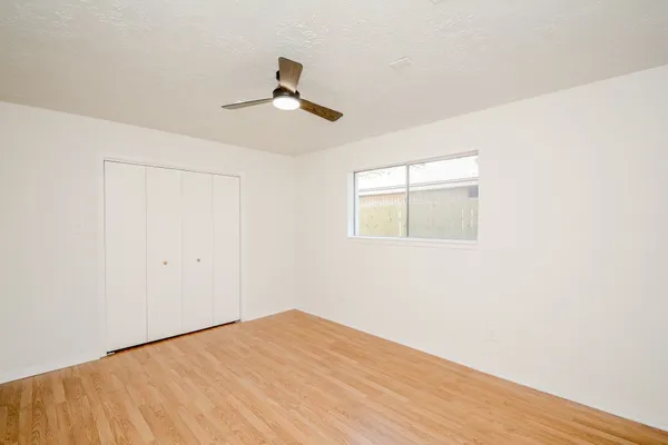 a view of empty room with wooden floor