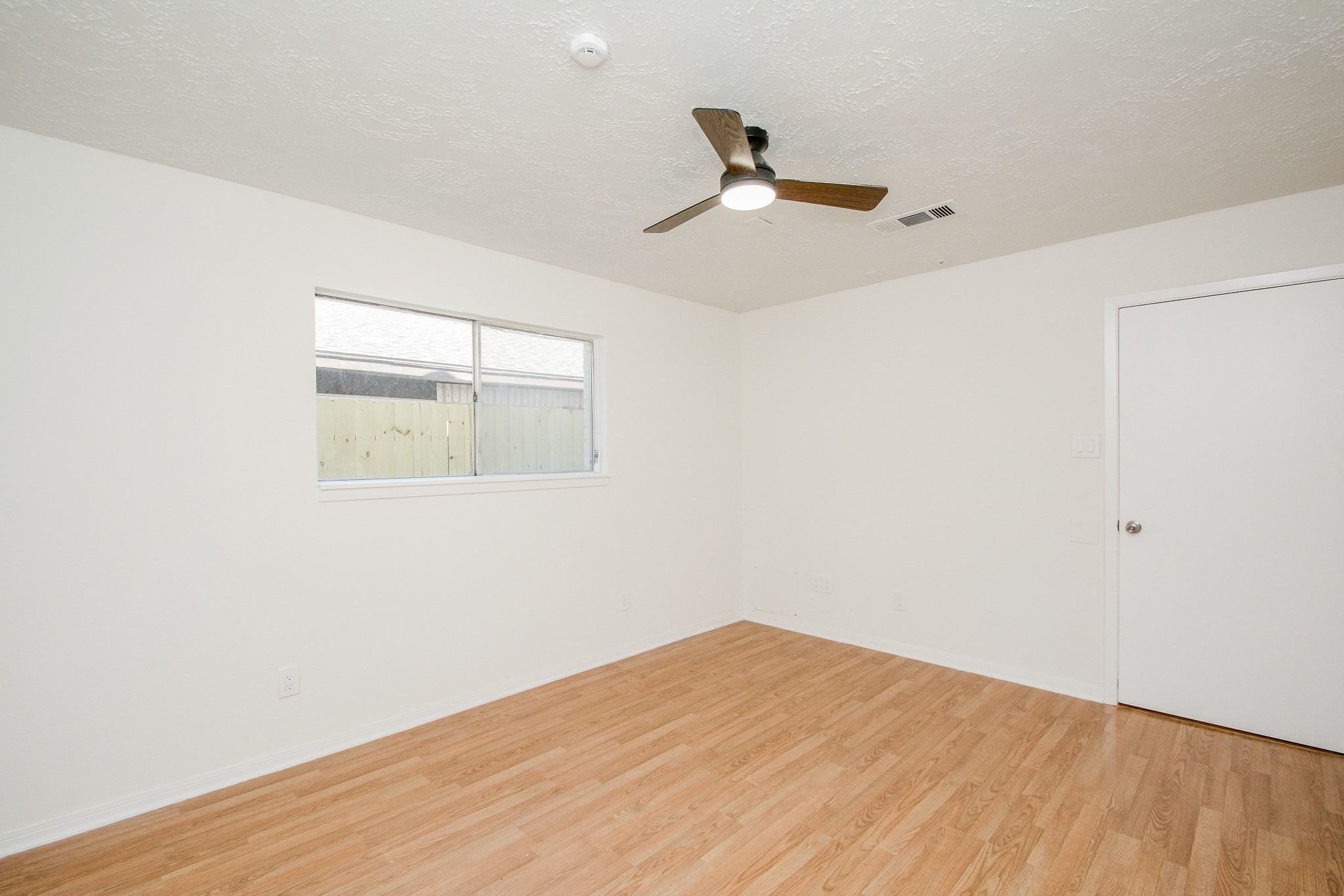4307 Sloangate Drive Spring, TX 77373 - Photo 19 of 22 a view of a room with wooden floor and fan