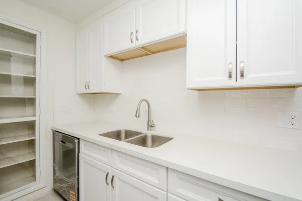 a kitchen with a sink and cabinets