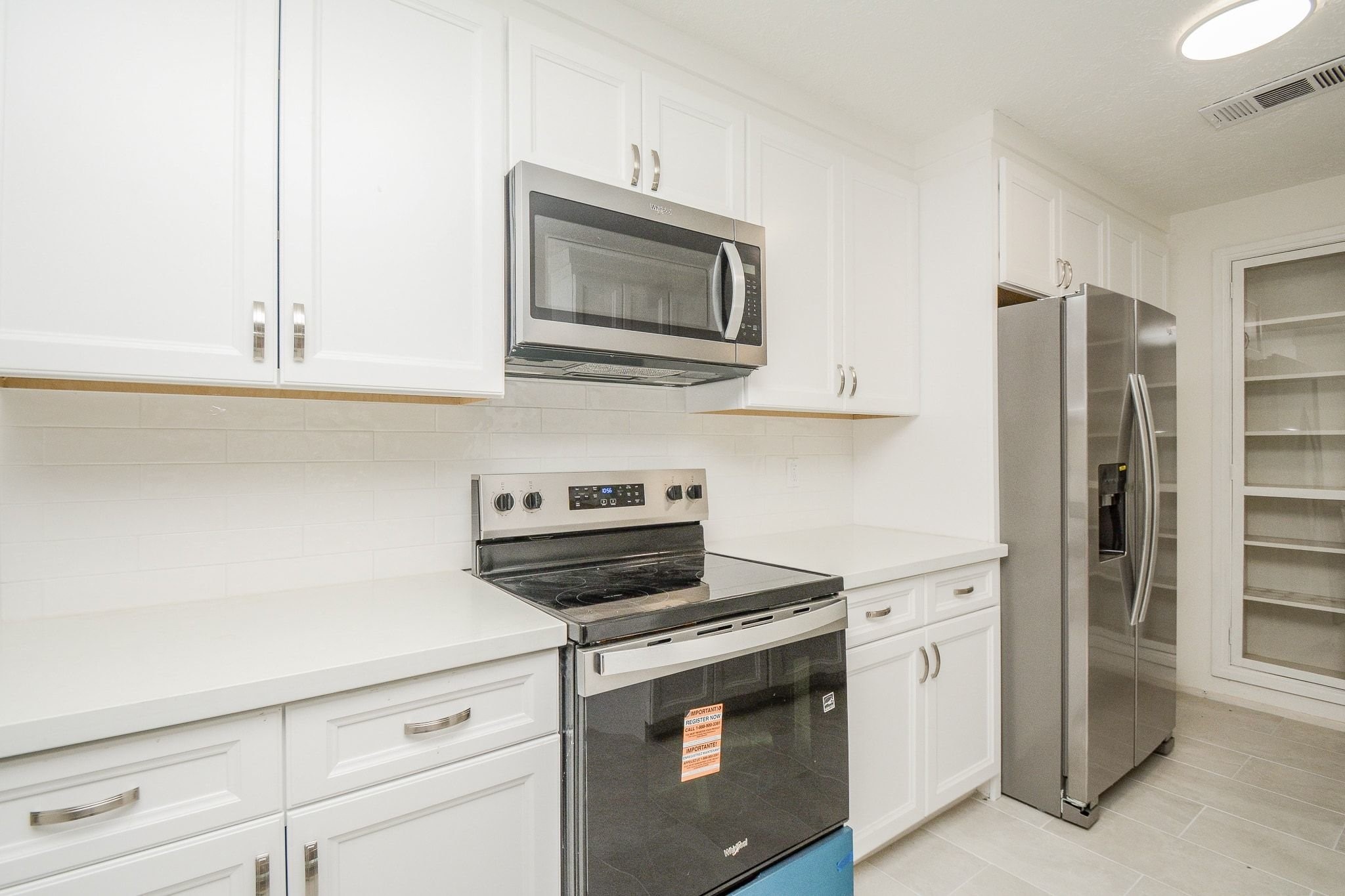 4307 Sloangate Drive Spring, TX 77373 - Photo 8 of 22 a kitchen with stainless steel appliances a stove microwave and refrigerator