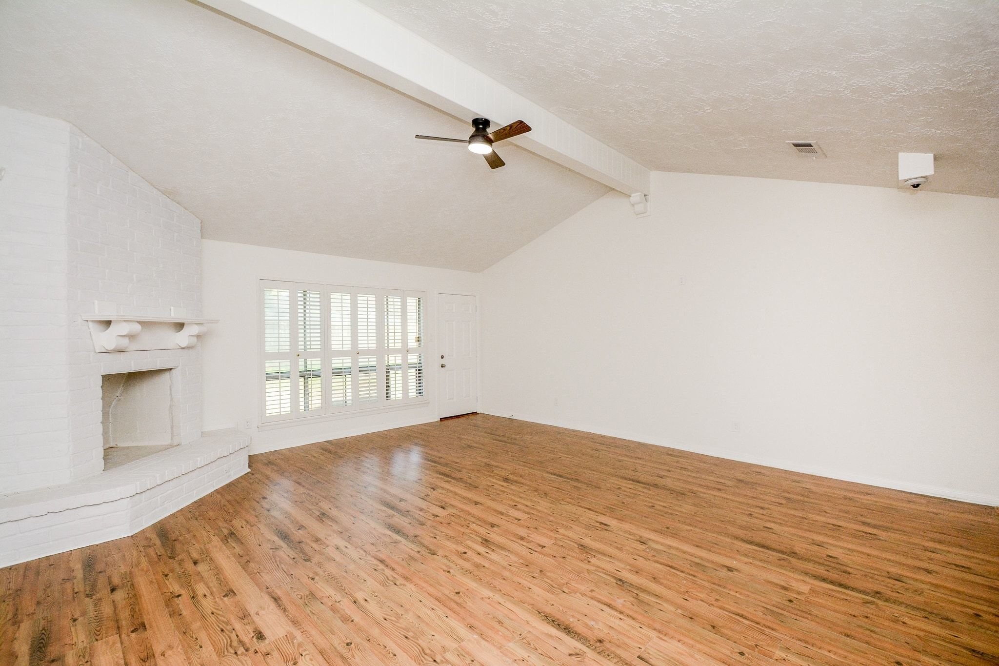 4307 Sloangate Drive Spring, TX 77373 - Photo 10 of 22 a view of an empty room with a window and wooden floor