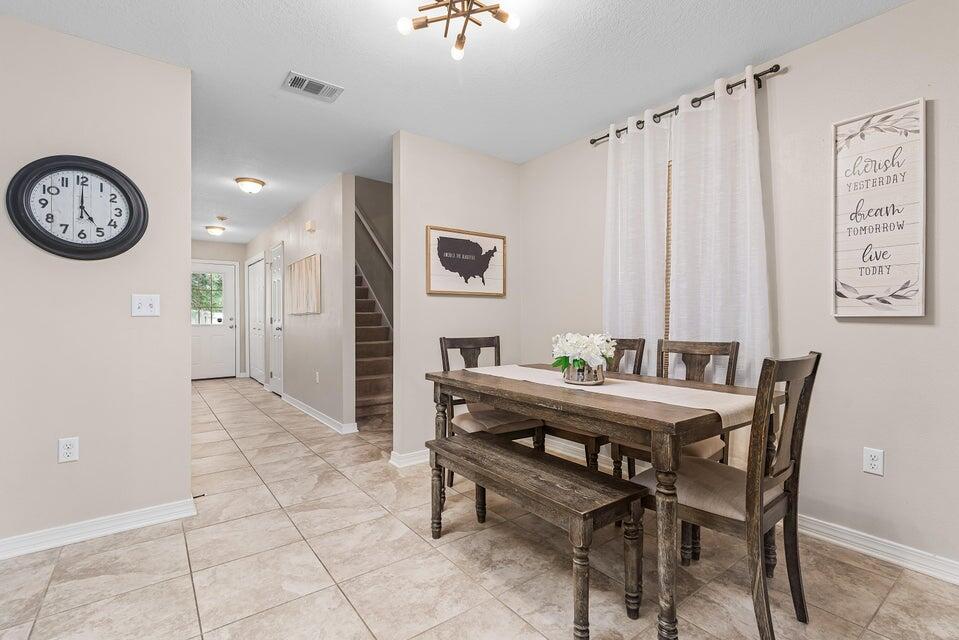 102 Lear Court Crestview, FL 32539 - Photo 11 of 37 a view of a dining room with furniture and a chandelier