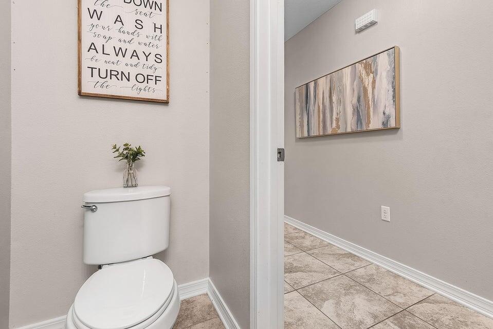 102 Lear Court Crestview, FL 32539 - Photo 17 of 37 a white toilet sitting next to a bathroom sink