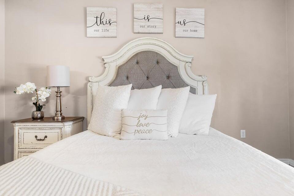 102 Lear Court Crestview, FL 32539 - Photo 18 of 37 a bedroom with a bed and a chandelier