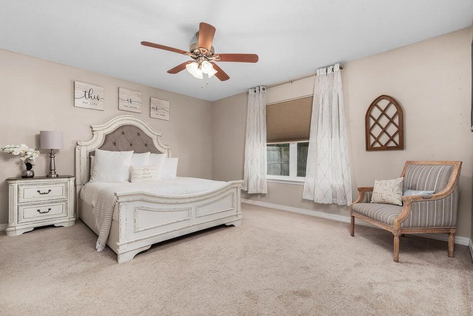 102 Lear Court Crestview, FL 32539 - Photo 19 of 37 a bedroom with a bed and a chandelier