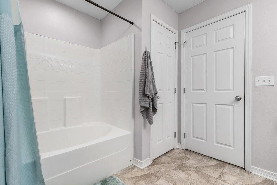 102 Lear Court Crestview, FL 32539 - Photo 22 of 37 a bathroom with a bathtub and a shower