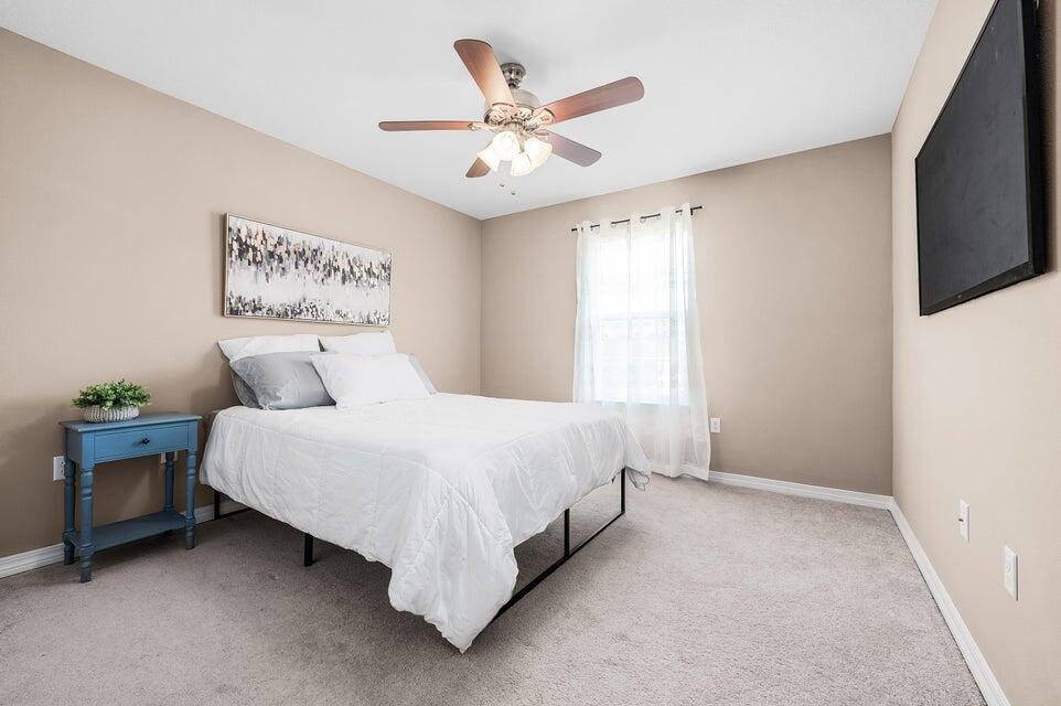 102 Lear Court Crestview, FL 32539 - Photo 27 of 37 a bedroom with a bed and a ceiling fan