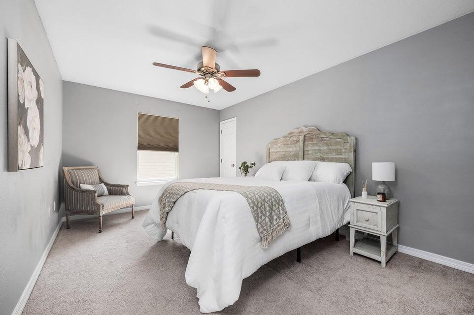 102 Lear Court Crestview, FL 32539 - Photo 32 of 37 a spacious bedroom with a bed and a chandelier