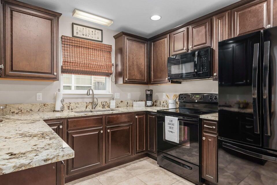102 Lear Court Crestview, FL 32539 - Photo 5 of 37 a kitchen with stainless steel appliances granite countertop a stove sink microwave and refrigerator