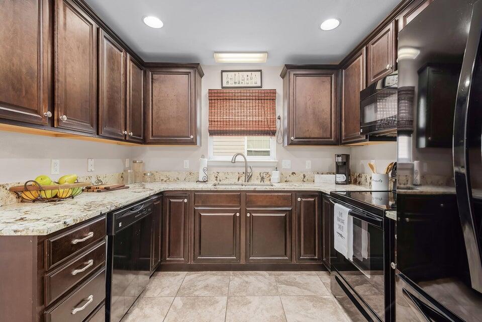 102 Lear Court Crestview, FL 32539 - Photo 6 of 37 a kitchen with a sink stove top oven and cabinets