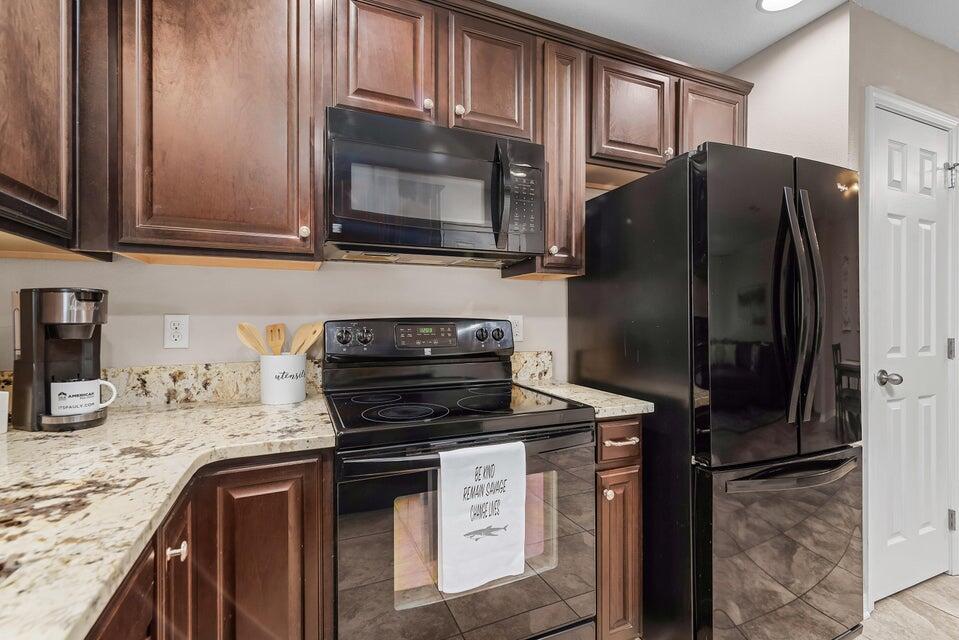 102 Lear Court Crestview, FL 32539 - Photo 7 of 37 a kitchen with stainless steel appliances granite countertop a refrigerator stove and microwave