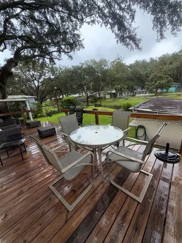 a view of a chairs and table on the deck
