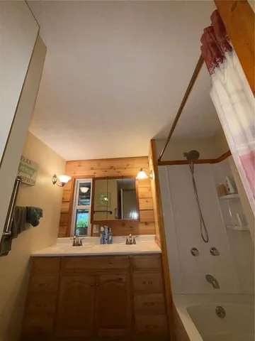 a bathroom with a tub and shower