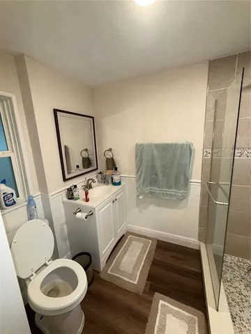 a bathroom with a toilet sink and mirror