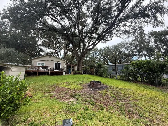a front view of a house with a yard and trees
