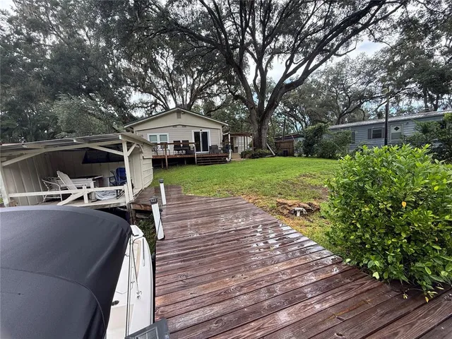 a view of a house with backyard and sitting area