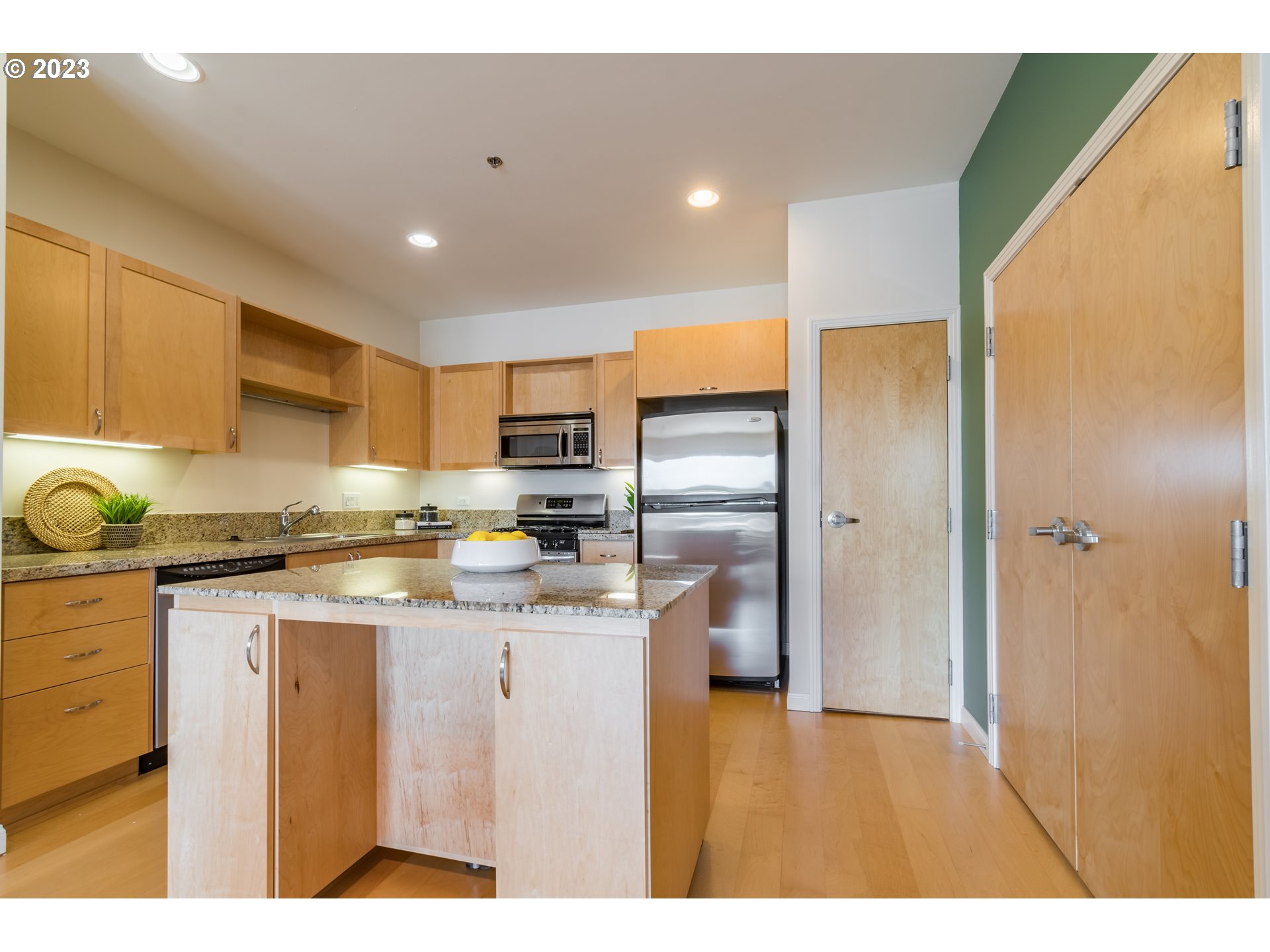 1375 Olive Street, Unit 308 Eugene, OR 97401 - Photo 11 of 35 a kitchen with stainless steel appliances granite countertop a sink a stove and a refrigerator