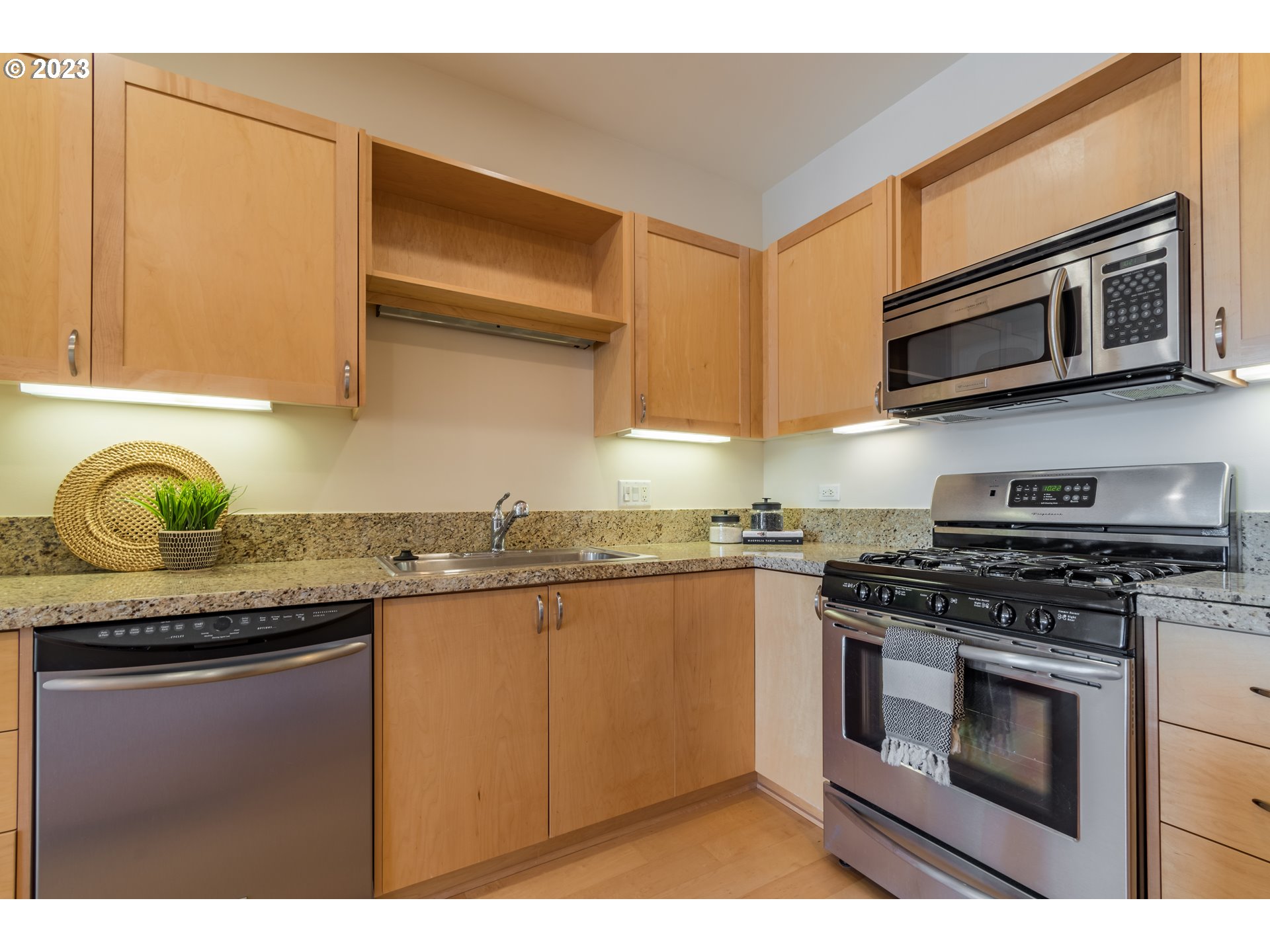 1375 Olive Street, Unit 308 Eugene, OR 97401 - Photo 14 of 35 a kitchen with stainless steel appliances granite countertop a stove and a microwave