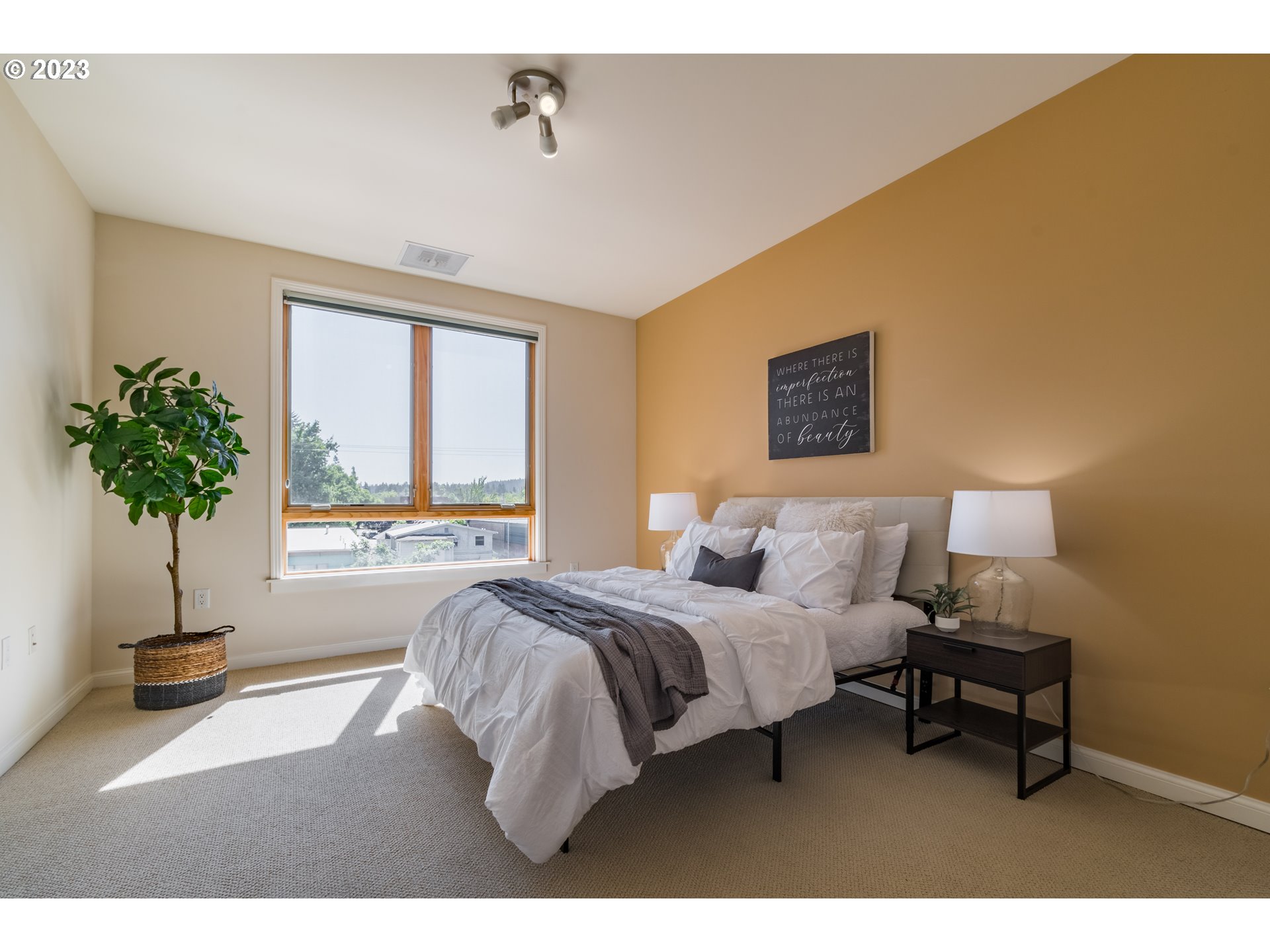 1375 Olive Street, Unit 308 Eugene, OR 97401 - Photo 19 of 35 a bedroom with a bed lamp and a potted plant