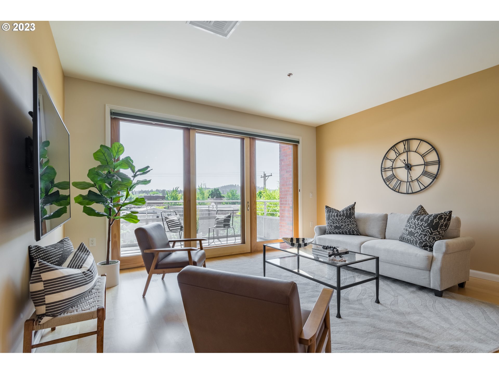 1375 Olive Street, Unit 308 Eugene, OR 97401 - Photo 6 of 35 a living room with furniture potted plant and a large window