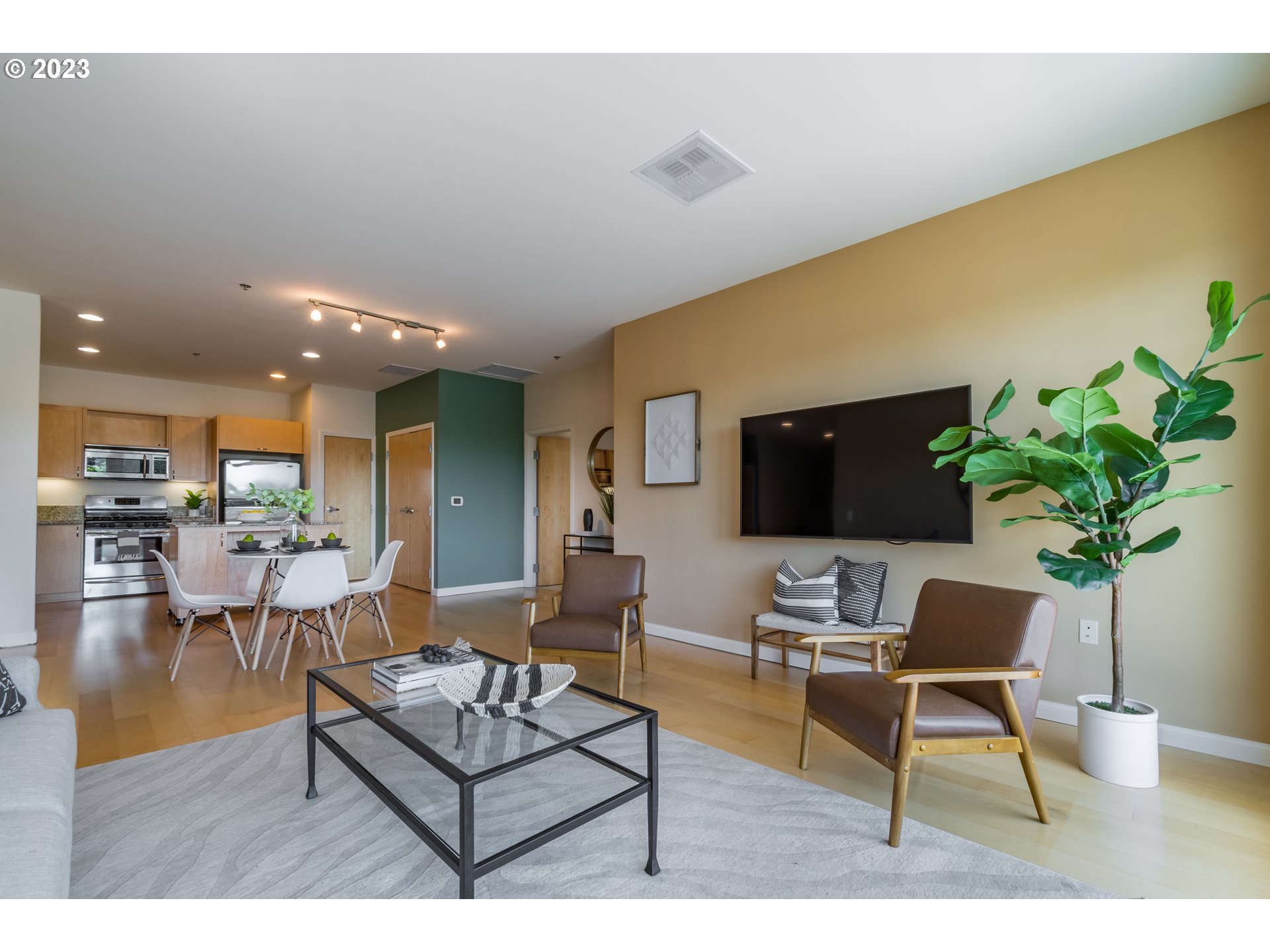 1375 Olive Street, Unit 308 Eugene, OR 97401 - Photo 7 of 35 a living room with furniture and a flat screen tv