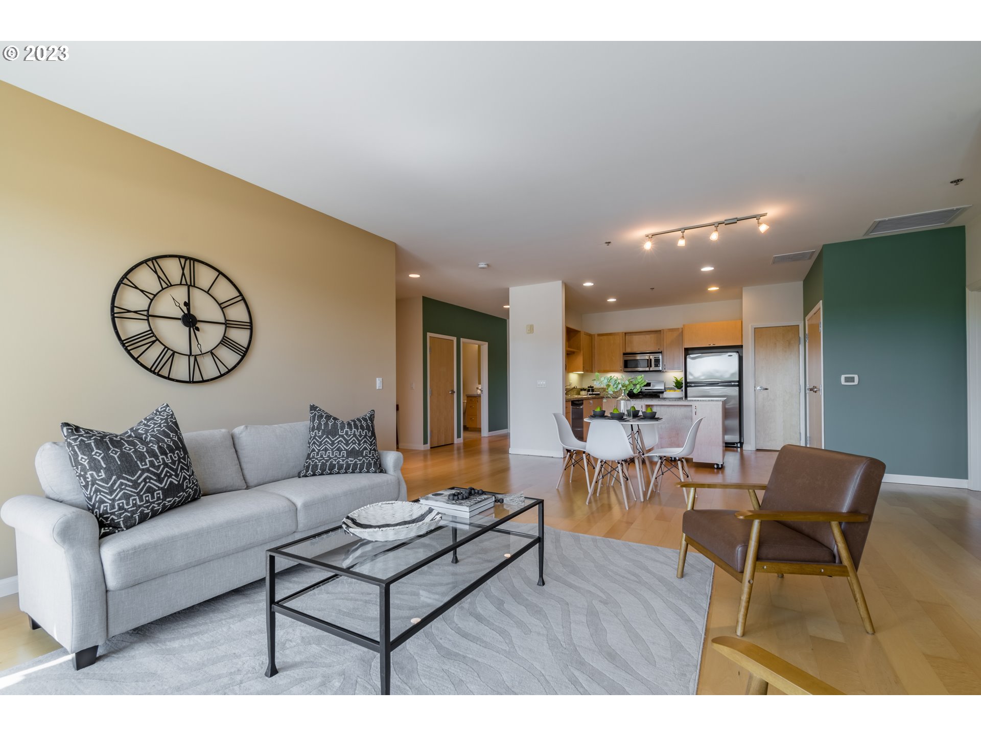 1375 Olive Street, Unit 308 Eugene, OR 97401 - Photo 8 of 35 a living room with furniture and a wooden floor