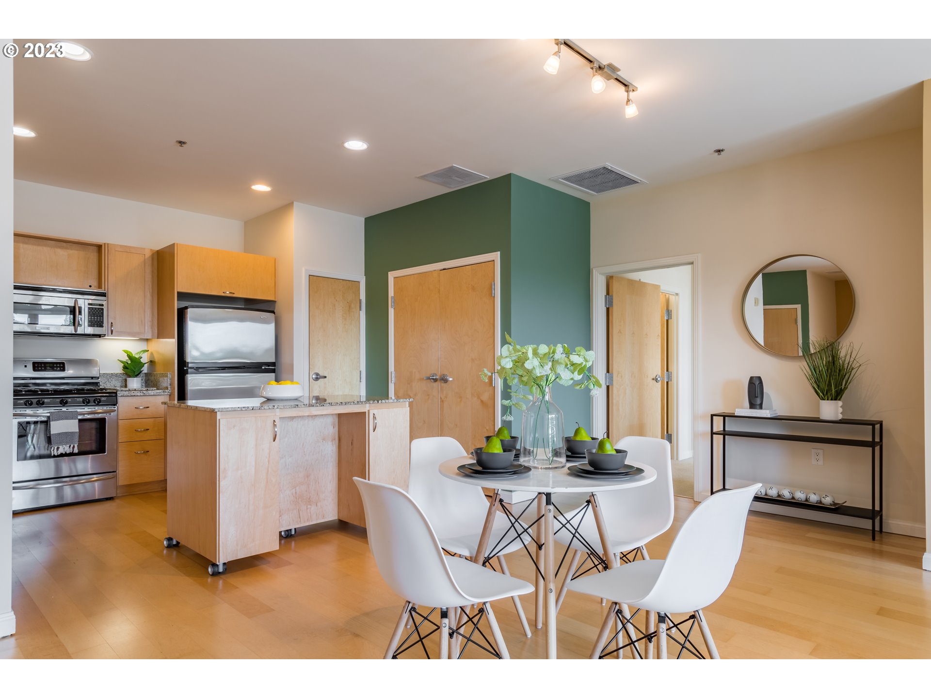 1375 Olive Street, Unit 308 Eugene, OR 97401 - Photo 10 of 35 a living room with furniture a flat screen tv and kitchen view