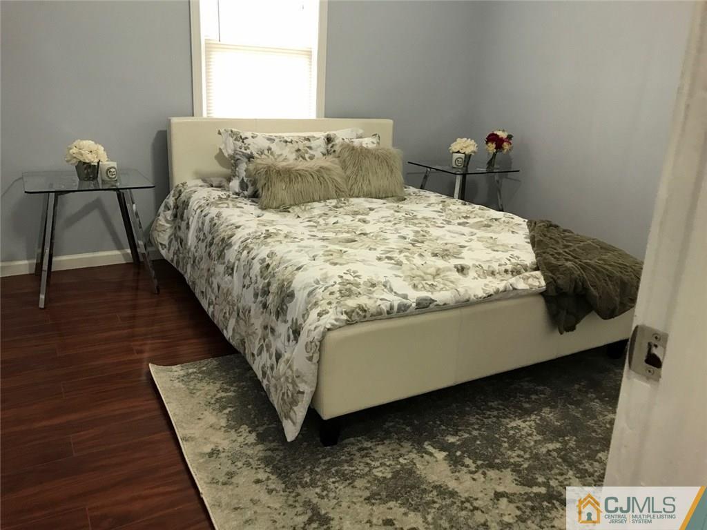 111 Old Post Road Edison, NJ 08817 - Photo 3 of 19 a bed sitting in a bedroom next to a window