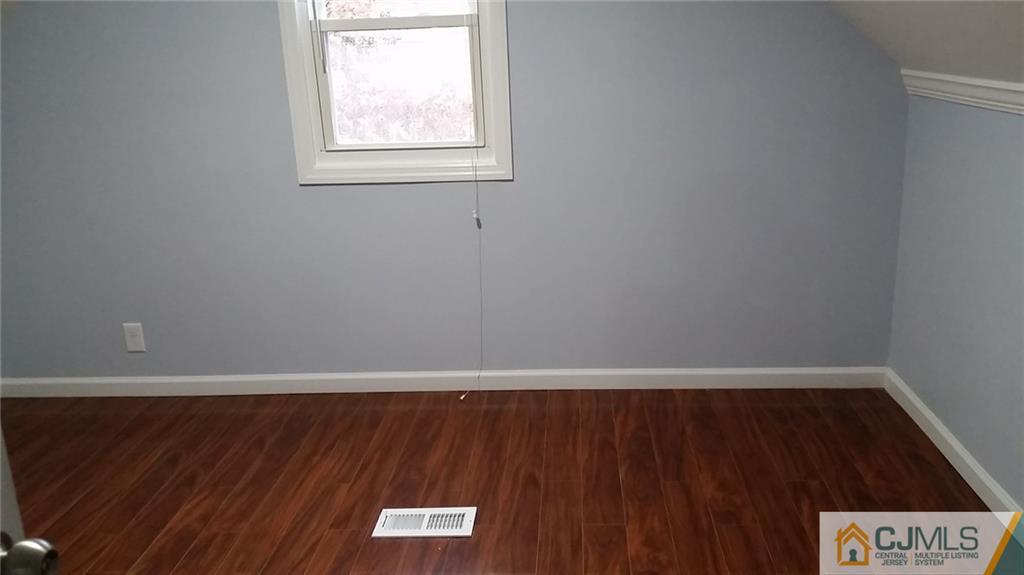 111 Old Post Road Edison, NJ 08817 - Photo 6 of 19 a view of an empty room with wooden floor and a window