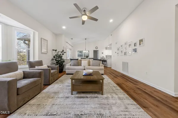 a living room with furniture and a chandelier