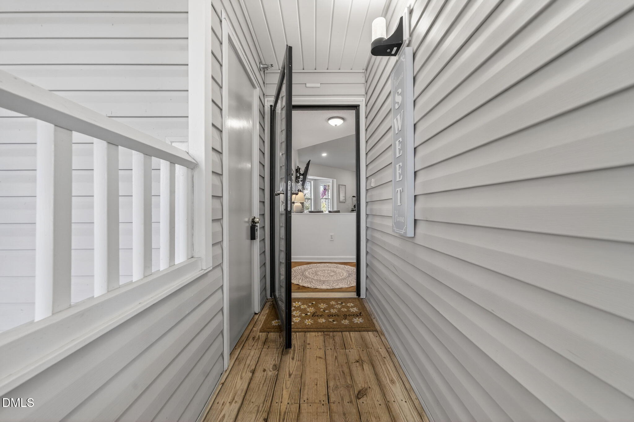 1911 Falls Landing Drive, Unit 203 Raleigh, NC 27614 - Photo 2 of 39 a view of a balcony with wooden floor and staircase