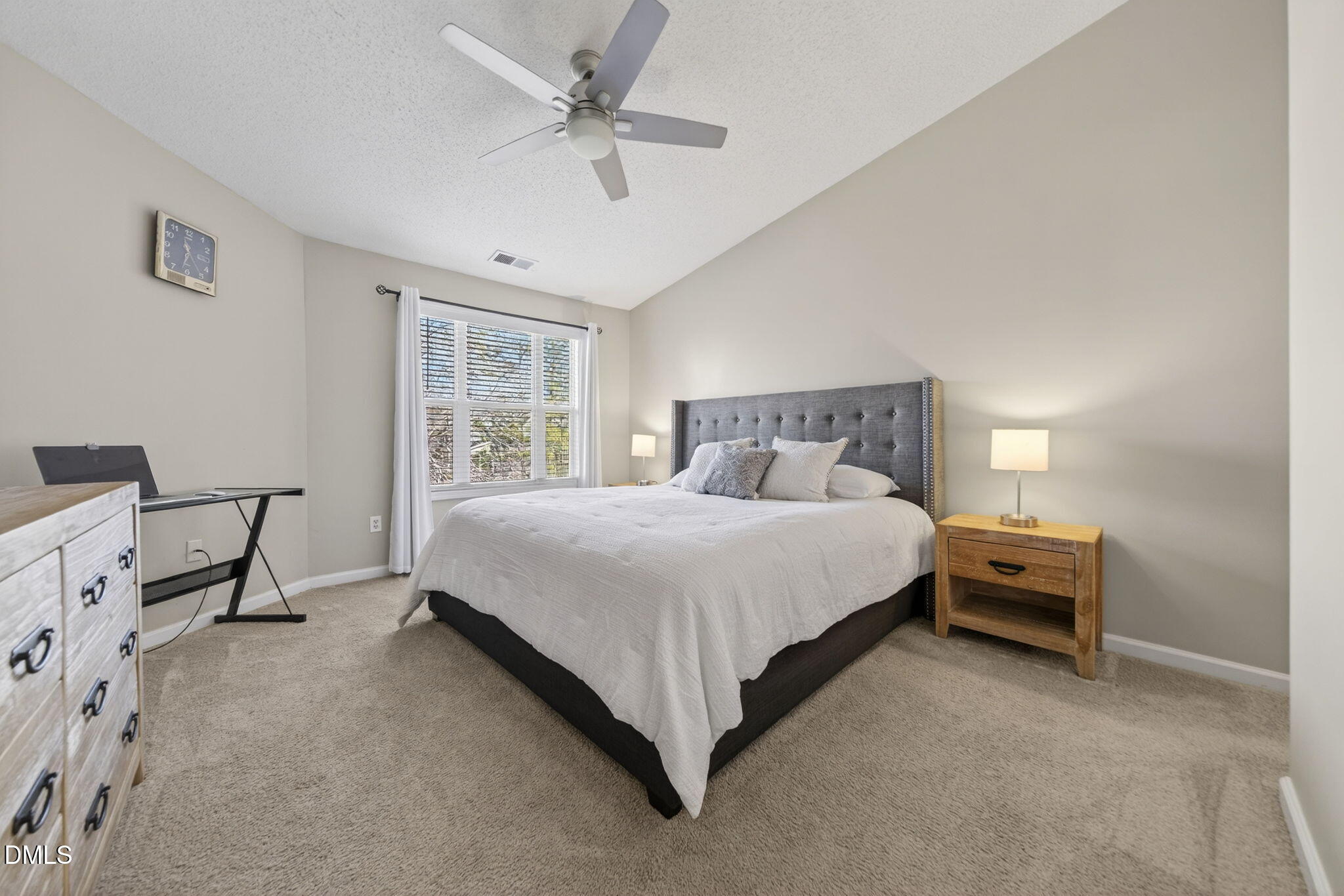 1911 Falls Landing Drive, Unit 203 Raleigh, NC 27614 - Photo 21 of 39 a bedroom with a bed and a chandelier