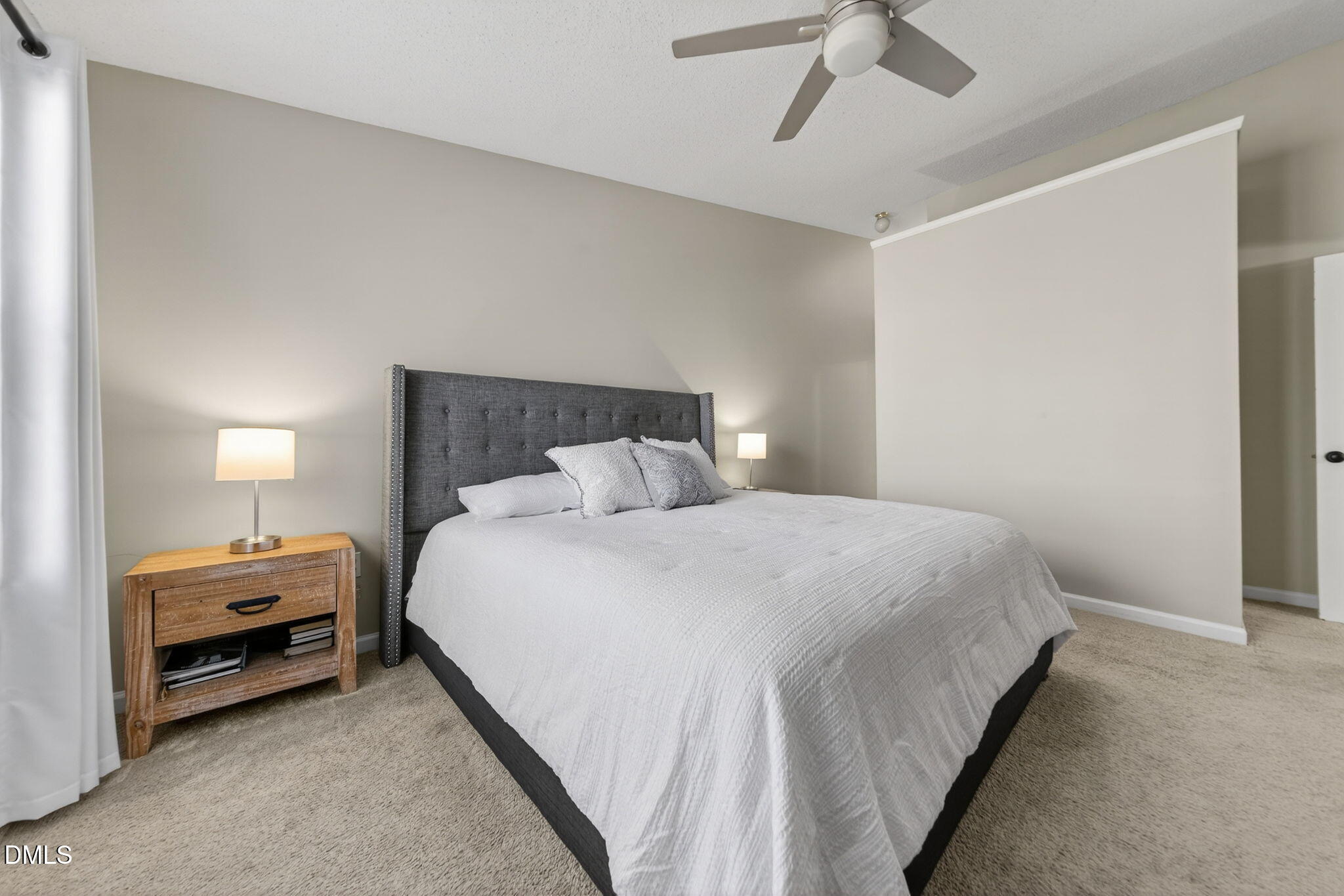 1911 Falls Landing Drive, Unit 203 Raleigh, NC 27614 - Photo 22 of 39 a bedroom with a bed and a ceiling fan