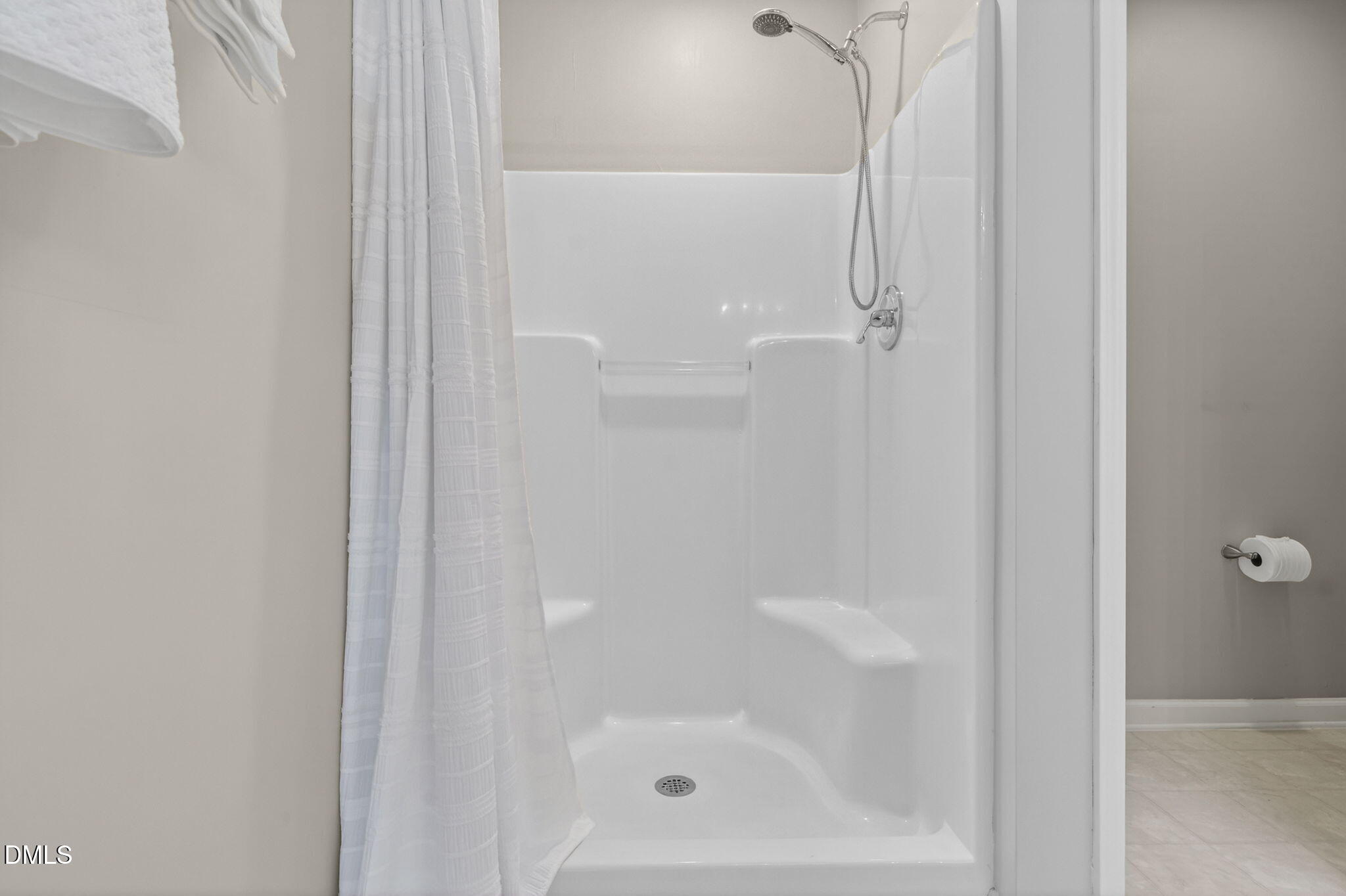 1911 Falls Landing Drive, Unit 203 Raleigh, NC 27614 - Photo 27 of 39 a bathroom with a glass shower door