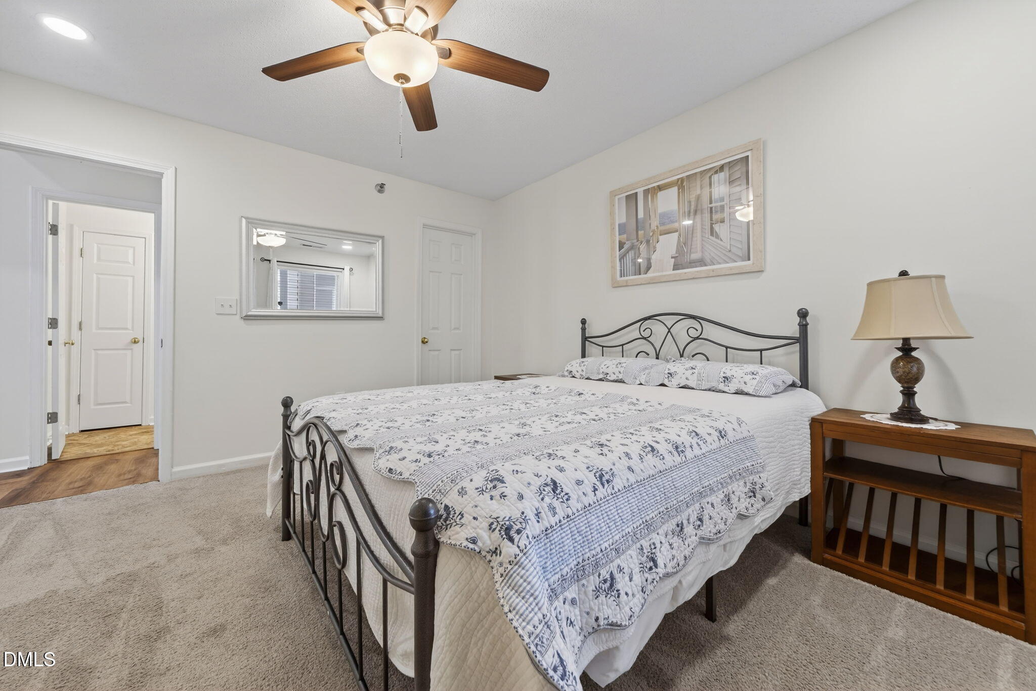 1911 Falls Landing Drive, Unit 203 Raleigh, NC 27614 - Photo 29 of 39 a bedroom with a bed and a chandelier