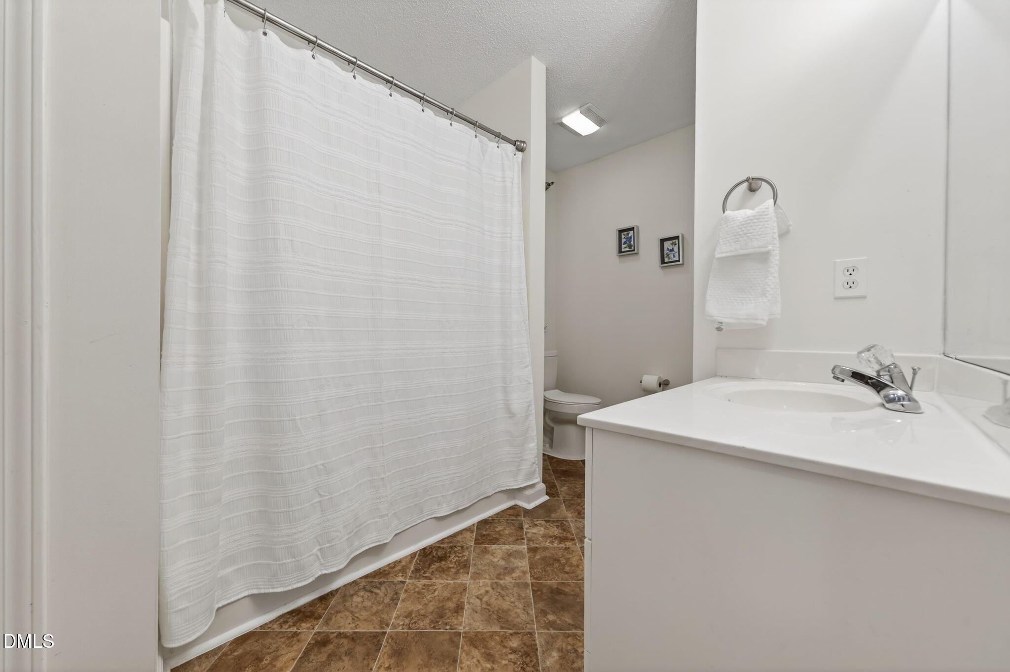 1911 Falls Landing Drive, Unit 203 Raleigh, NC 27614 - Photo 30 of 39 a bathroom with a sink and a mirror