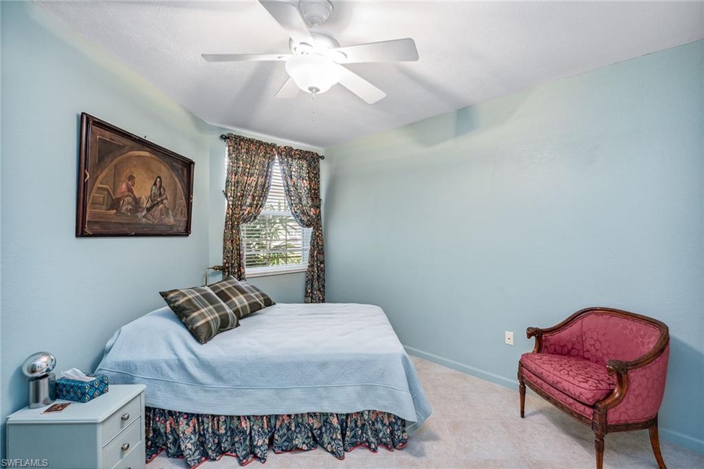 3985 Deer Crossing Court, Unit 103 Naples, FL 34114 - Photo 12 of 37 a bedroom with furniture and a window