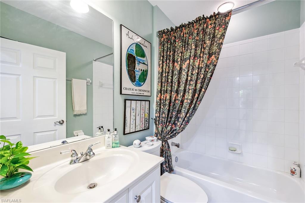 3985 Deer Crossing Court, Unit 103 Naples, FL 34114 - Photo 13 of 37 a bathroom with a sink toilet and shower
