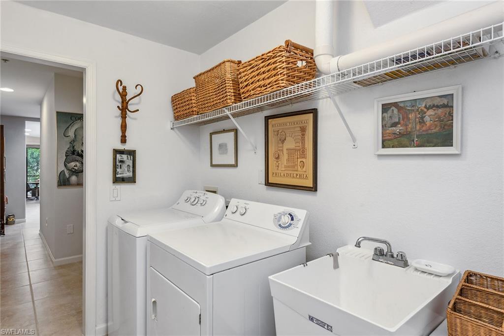 3985 Deer Crossing Court, Unit 103 Naples, FL 34114 - Photo 14 of 37 a bathroom with a sink and a mirror