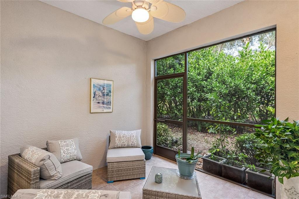 3985 Deer Crossing Court, Unit 103 Naples, FL 34114 - Photo 16 of 37 a living room with furniture and a large window