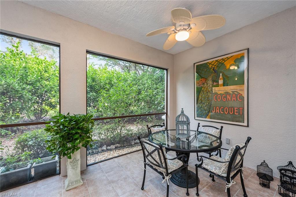 3985 Deer Crossing Court, Unit 103 Naples, FL 34114 - Photo 17 of 37 a view of a dining room with furniture window and outside view