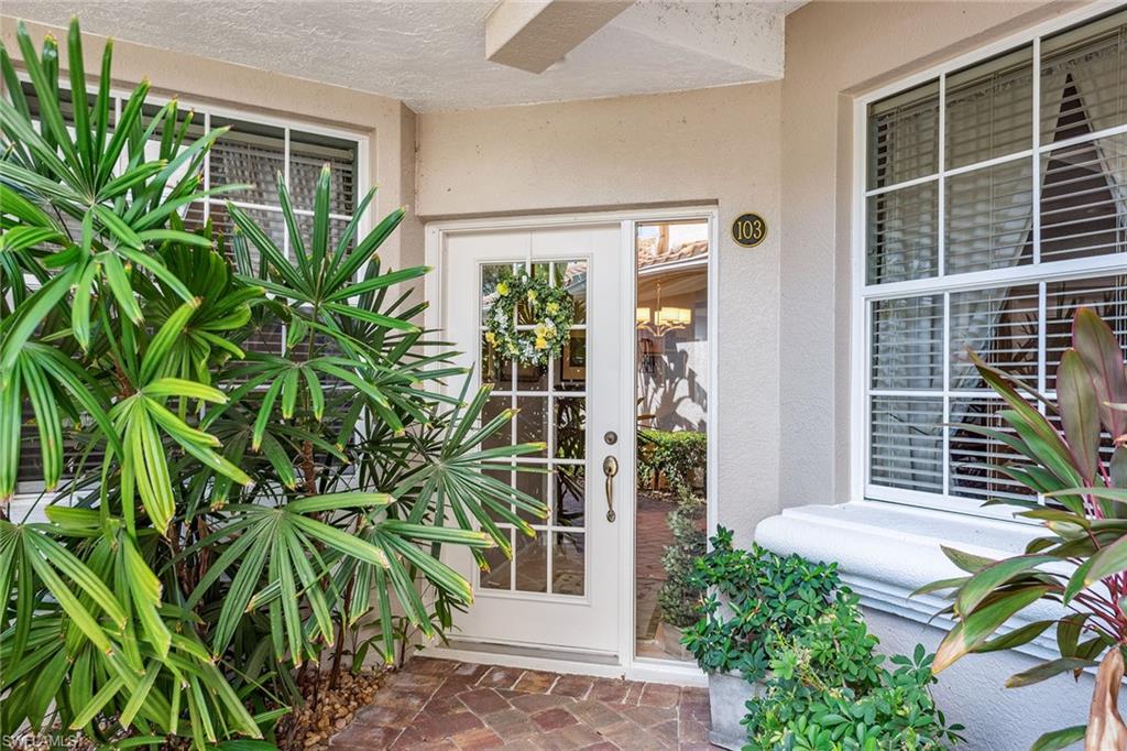 3985 Deer Crossing Court, Unit 103 Naples, FL 34114 - Photo 2 of 37 a house with a plant and windows