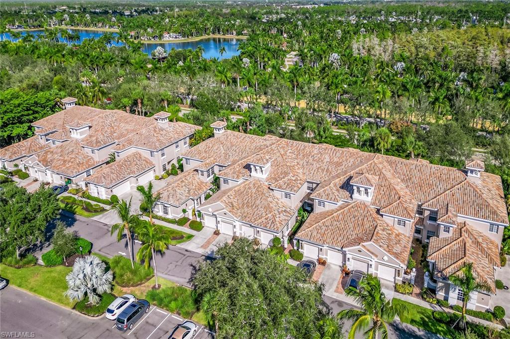 3985 Deer Crossing Court, Unit 103 Naples, FL 34114 - Photo 21 of 37 an aerial view of a house with yard